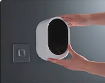 Gently lifting the unit off, leaving the adhesive mount on the wall