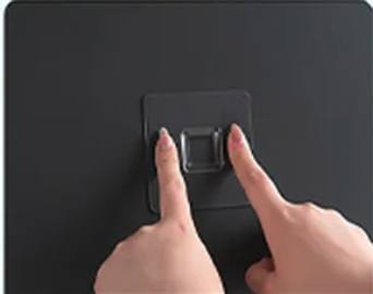 Pressing the adhesive mounting plate flat against the wall